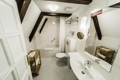 a bathroom with a toilet and a sink and a mirror at Archibald At the Charles Bridge in Prague