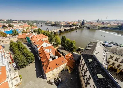 an aerial view of a city with a river and buildings at Archibald At the Charles Bridge in Prague
