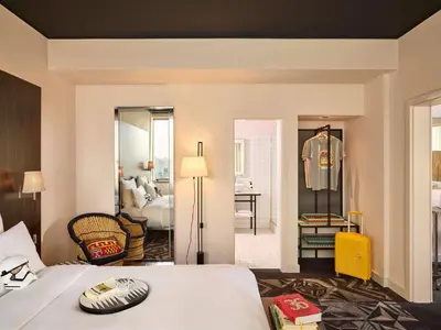 a hotel room with a bed and a room with a bedroom at Mama Shelter Prague in Prague