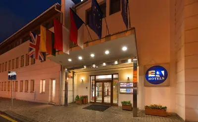 a hotel with flags on the side of a building at EA Hotel Populus in Prague