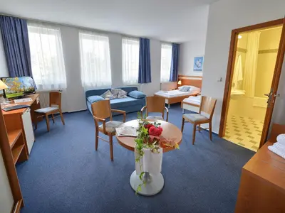 a room with a living room with a table and chairs at EA Hotel Populus in Prague
