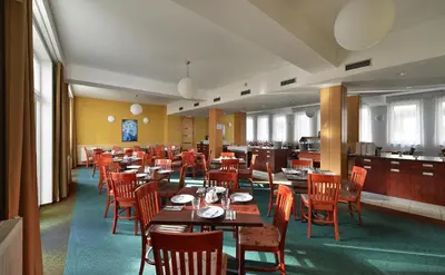 a dining room with wooden tables and chairs at EA Hotel Populus in Prague