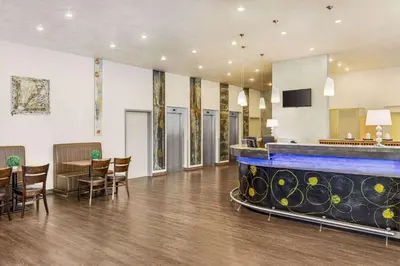 a lobby with a large aquarium in the middle of a room at Amedia Express Prague, Trademark Collection by Wyndham in Prague