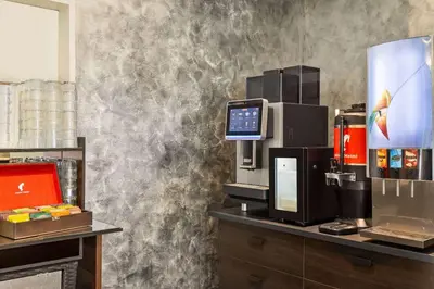 a room with a computer on a counter with a wall at Amedia Express Prague, Trademark Collection by Wyndham in Prague