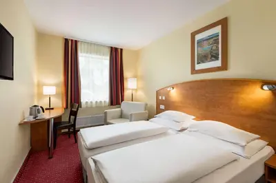 a hotel room with a large bed and a desk at Amedia Express Prague, Trademark Collection by Wyndham in Prague