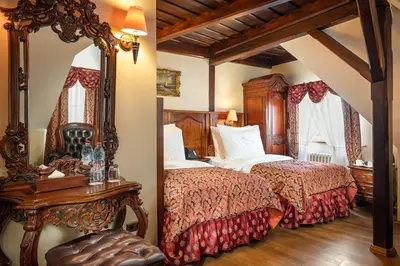 a bedroom with a large bed and a mirror at Hotel U Prince Prague by BHG in Prague
