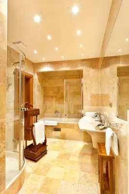 a bathroom with a tub and a sink and a shower at Hotel U Prince Prague by BHG in Prague