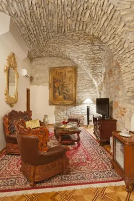 a living room with a couch and a stone wall at Hotel U Prince Prague by BHG in Prague