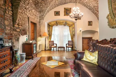 a living room with a couch and a stone wall at Hotel U Prince Prague by BHG in Prague