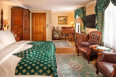 a bedroom with a bed and a chair at Hotel U Prince Prague by BHG in Prague