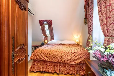 a bedroom with a bed and a mirror at Hotel U Prince Prague by BHG in Prague