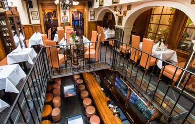 an overhead view of a restaurant with tables and chairs at Hotel U Zlatého Stromu Prague by BHG in Prague
