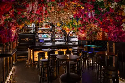 a bar with flowers on the walls at Hotel U Zlatého Stromu Prague by BHG in Prague