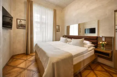 a bathroom with a shower and a sink and a toilet at Monastery Hotel in Prague
