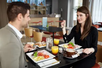 a restaurant with tables and chairs and a buffet at Occidental Praha in Prague