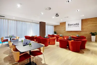 a restaurant with red chairs and tables in a room at Occidental Praha in Prague