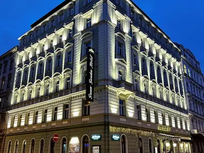 a large building with a sign on the side of it at Green Garden Hotel in Prague