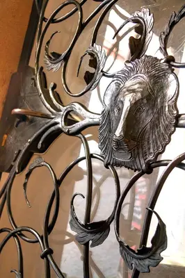 a metal fence with a lion head on it at Red Lion Hotel in Prague