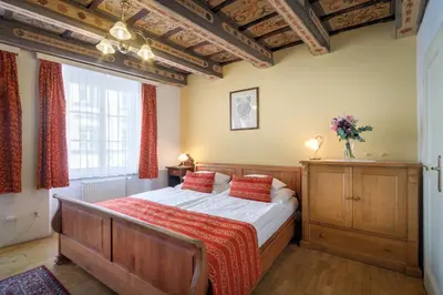 a bedroom with a bed and a large window at Red Lion Hotel in Prague
