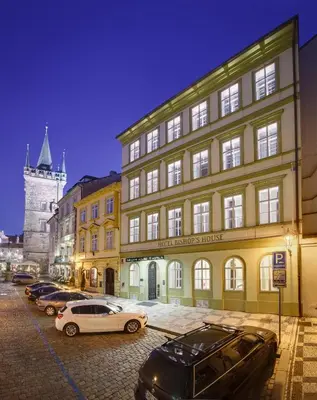 a building with cars parked in front of it at Bishop's House in Prague
