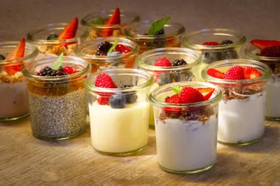 a group of mason jars filled with yogurt and berries at Bishop's House in Prague