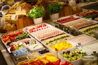 a buffet filled with lots of different fruits and vegetables at Bishop's House in Prague