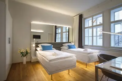 a living room with two beds and a couch at Bishop's House in Prague