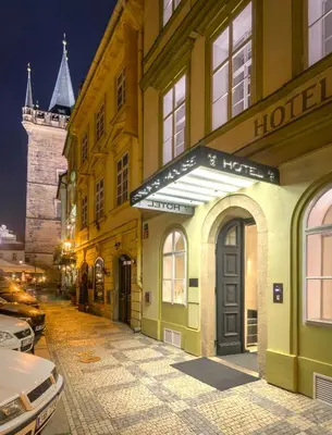 a building with a hotel on a street at night at Bishop's House in Prague