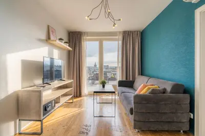 a living room with a couch and a television at EA ApartHotel Melantrich in Prague