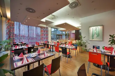 a restaurant with tables and chairs in a room at Rezidence Emmy in Prague