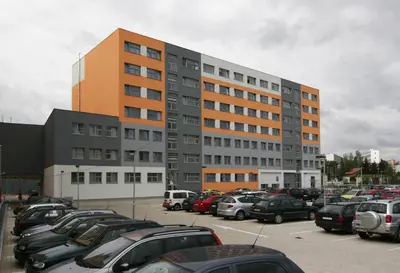 a parking lot with cars parked in front of a building at Rezidence Emmy in Prague