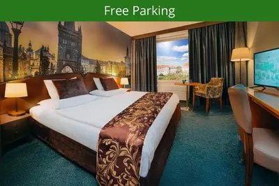 a hotel room with a bed and a desk at Plaza Boutique Hotel - Czech Leading Hotels in Prague