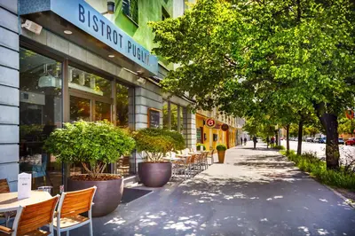a sidewalk with tables and chairs in front of a building at Plaza Boutique Hotel - Czech Leading Hotels in Prague
