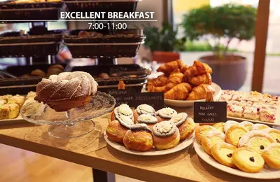 a bakery with a variety of pastries on a counter at Plaza Boutique Hotel - Czech Leading Hotels in Prague