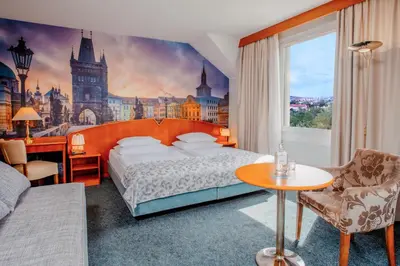 a bedroom with a king sized bed with a castle mural at Plaza Boutique Hotel - Czech Leading Hotels in Prague