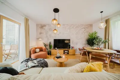 a living room with a couch and a table at Prague Days - Two-bedroom Loft with 3 Terraces and Parking in Hip Žižkov in Prague