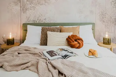 a bed with a blanket and a plate of food on it at Prague Days - Two-bedroom Loft with 3 Terraces and Parking in Hip Žižkov in Prague