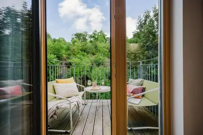 a view of a balcony with a table and chairs at Prague Days - Two-bedroom Loft with 3 Terraces and Parking in Hip Žižkov in Prague