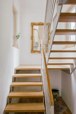 a staircase in a house with a mirror at Prague Days - Two-bedroom Loft with 3 Terraces and Parking in Hip Žižkov in Prague