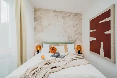 a bedroom with a bed with two lights on it at Prague Days - Two-bedroom Loft with 3 Terraces and Parking in Hip Žižkov in Prague