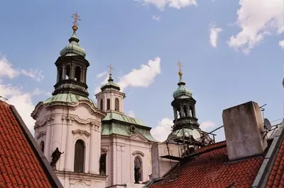 a church with two towers on top of a roof at U Tří Bubnů in Prague
