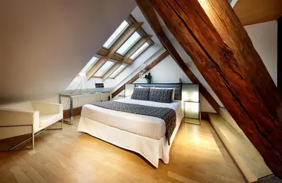 a bedroom with a large bed in a attic at Eurostars Thalia in Prague