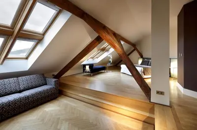 a attic living room with wooden beams and a couch at Eurostars Thalia in Prague