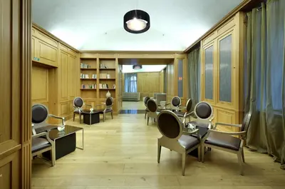 a salon with chairs and tables in a room at Eurostars Thalia in Prague