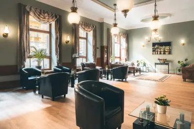 a living room with chairs and a table at Hotel Ariston Prague in Prague