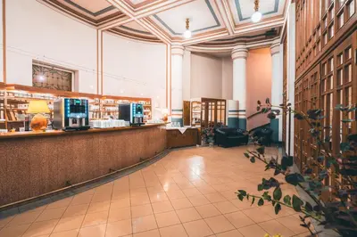 a large room with a bar in a library at Hotel Ariston Prague in Prague