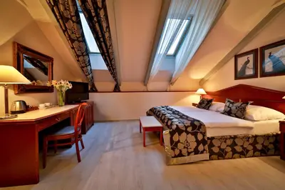 a hotel room with a bed and a desk at Carlton in Prague
