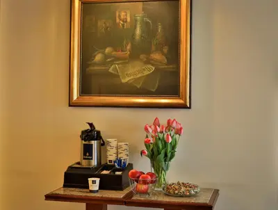 a table with flowers and a picture on the wall at Carlton in Prague