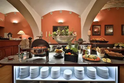 a kitchen with a buffet with plates and food at Carlton in Prague