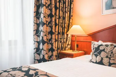 a hotel room with a bed and a window at Carlton in Prague